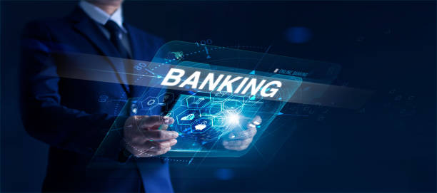 istock Businessman holding modern interface and word banking in hand with icon network connection on virtual screen dark background 1185373118
