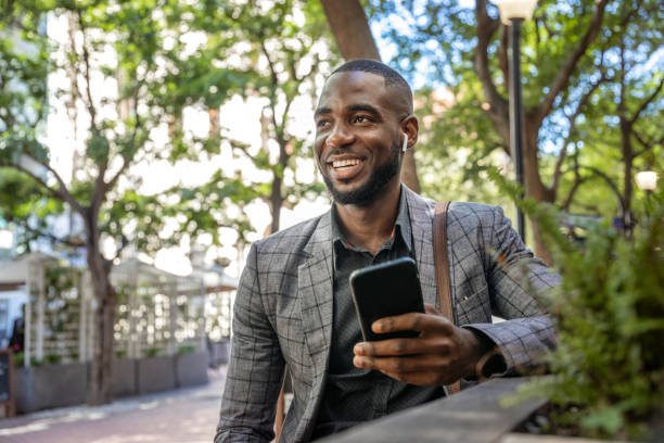 istock Young Man Sits In Cafe And Using Smart Phone 1185373170