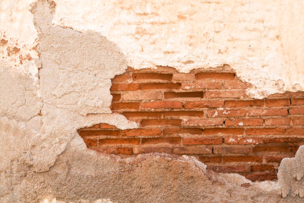 istock Damaged wall with red  brick part showing closeup, background/ texture. 1185376265