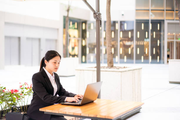 istock Young Asian businesswoman using a laptop 1185377106