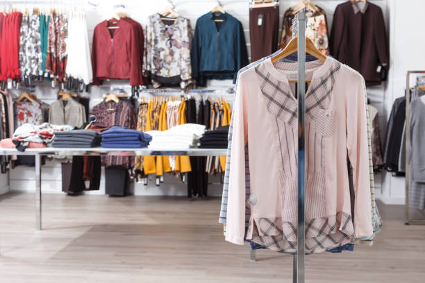 istock Stylish clothes on hangers and shelfs 1185378713