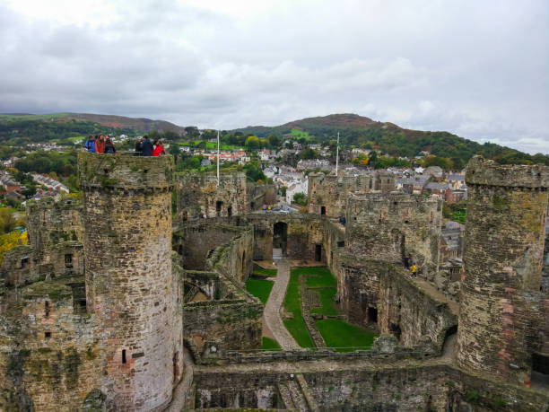 Conwy Castle, an ancient 13th Century stone built fortification in North Wales, with Conwy town at the background Conwy Castle, an ancient 13th Century stone built fortification in North Wales, with Conwy town at the background conwy castle stock pictures, royalty-free photos & images