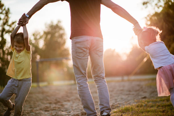 istock Father is spinning kids around 1185382348