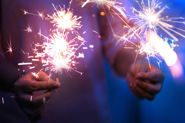 istock Hand of woman holding firework firework pyrotechnics and bokeh with blurry effect on the dark background for celebration concept 1185382612