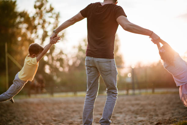 istock Father is spinning kids around 1185382734