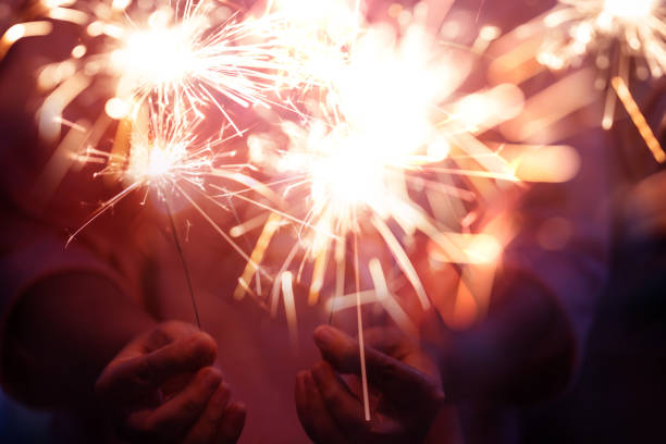 istock Hand of woman holding firework firework pyrotechnics and bokeh with blurry effect on the dark background for celebration concept 1185383094
