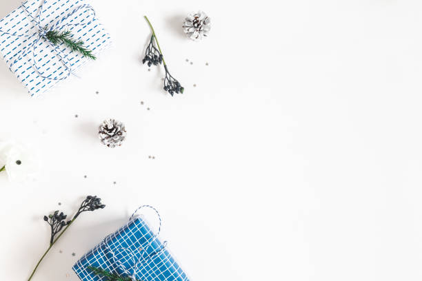 Christmas composition. Gift box, fir tree branches, decorations on white background. Christmas, winter, new year concept. Flat lay, top view, copy space