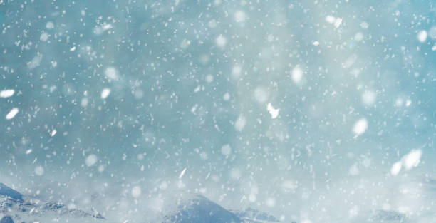 istock snowflakes on dark sky. Winter background 1185383875