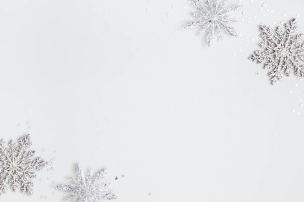 istock Christmas or winter composition. Frame made of silver snowflakes on pastel gray background. Christmas, winter, new year concept. Flat lay, top view, copy space 1185384301