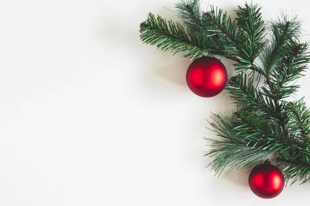 istock Christmas composition. Fir tree branches, red balls on white background. Christmas, winter, new year concept. Flat lay, top view, copy space 1185384542