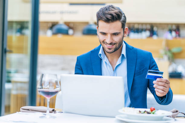 istock Businessman using credit card in restaurant 1185385360