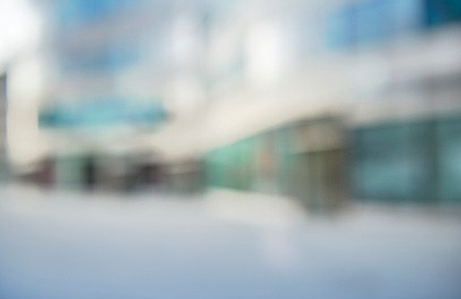 Defocused high res photograph of an urban place with office buildings and shops.