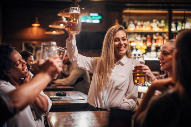 istock Beautiful women drinking beer in the pub 1185389429