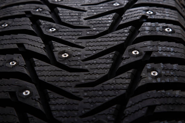 istock Winter studded car tire with snow spikes 1185389507