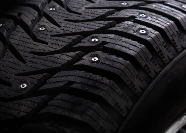 istock Winter studded car tire with snow spikes 1185389652