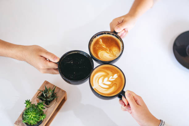 istock people enjoyed drinking and clinking coffee cups on the table in cafe 1185391140