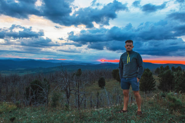 istock Man standing on top of cliff 1185391206