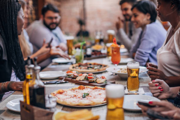 istock Group of friends sitting in restaurant 1185391242