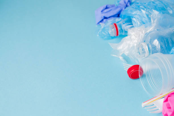 istock Top view of various kinds of disposable plastic waste on blue background, copy space 1185392166