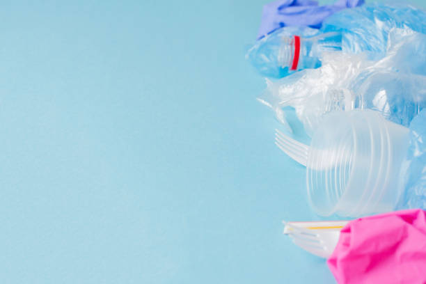 istock Top view of various kinds of disposable plastic waste on blue background, copy space 1185392231