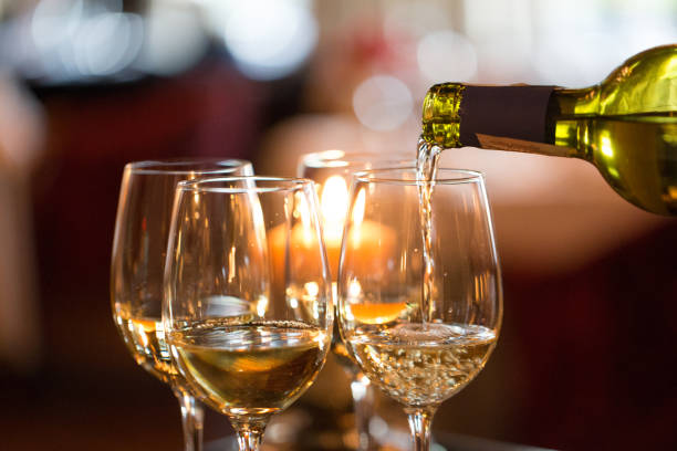 istock white wine pouring into a glass of wine 1185392245