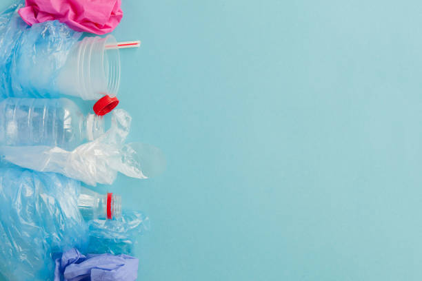 istock Top view of various kinds of disposable plastic waste on blue background, copy space 1185392262