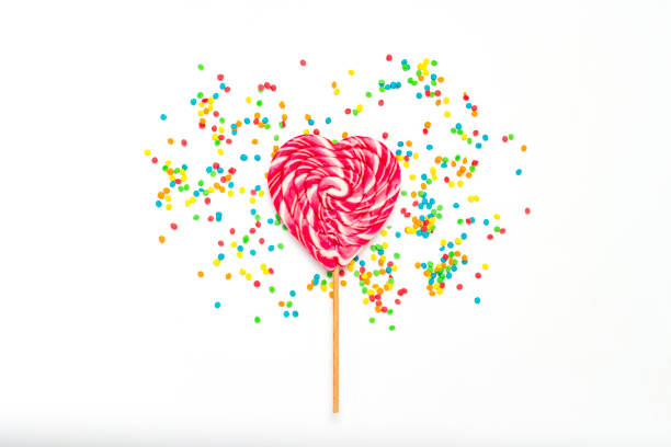istock Heart Lollipop and multi coloured sweets on a gently white backg 1185393947