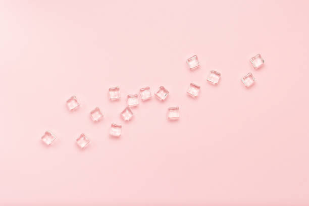 istock Ice cubes on a light pink background. Flat lay, top view 1185394393