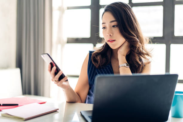 istock Businesswoman sitting working with laptop computer and using smartphone.creative business people planning in her workstation at modern work loft 1185395723