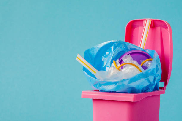 istock Studio shot of a pink big trash on blue background 1185396006