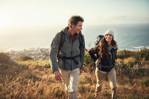 taking their date to the top of the mountain - couple smiling happiness people imagens e fotografias de stock