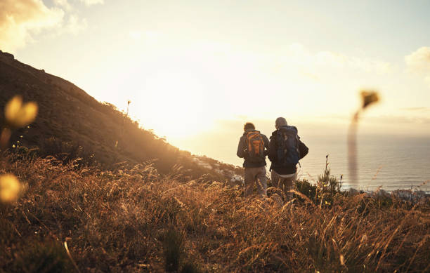 Nature gives you a reason to never be bored again Shot of a couple going for a hike up the mountain never stock pictures, royalty-free photos & images