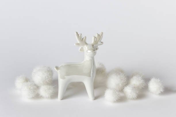 istock White glossy reindeer with white fluffy balls 1185397765