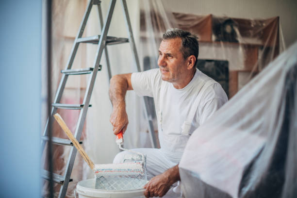 istock An older painter works to decorate the apartment with colors 1185397925