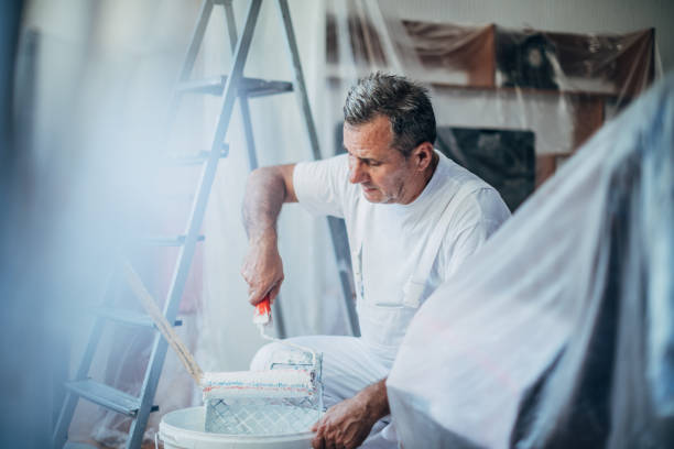 istock An older painter works to decorate the apartment with colors 1185397955