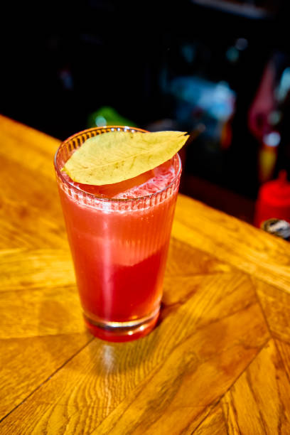 istock Red cocktail with Bay leaf poured into a tall glass 1185398250