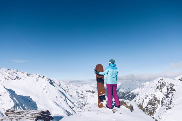 istock Female snowboarder at ski resort 1185399997