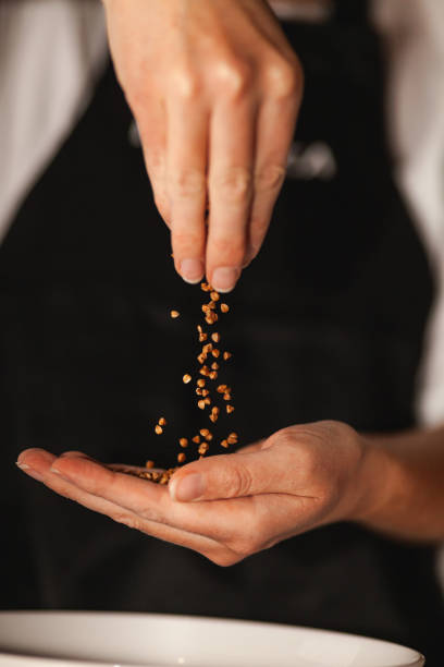 istock Buckwheat grains fall from one hand to another 1185402436