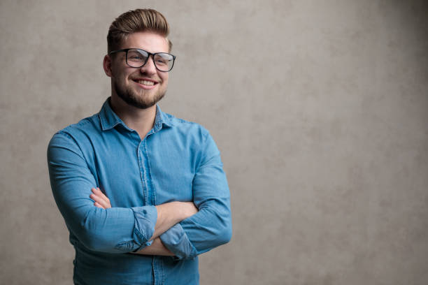 istock Confident casual man looking away with his hands folded 1185403190