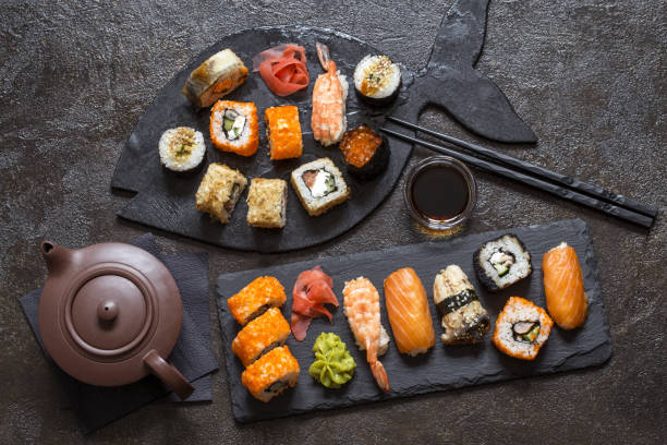istock sushi rolls with rice and fish, soy sauce on a dark background 1185403854