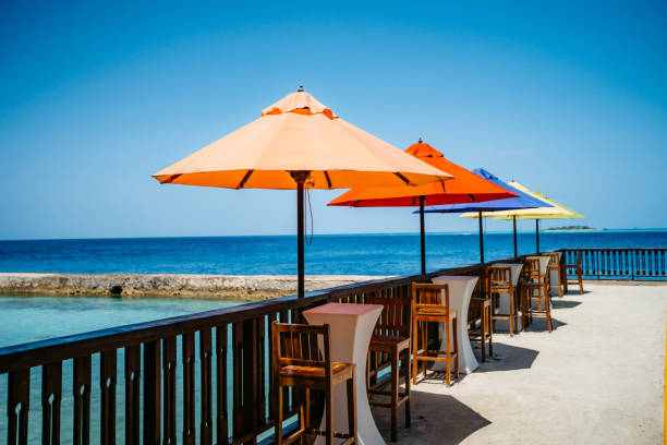 Colorful parasols in beach cafe on Maldives.