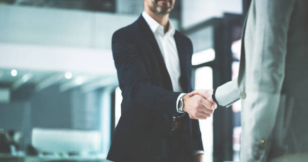 What a pleasure to meet you Closeup shot of two businesspeople shaking hands in an office partnership stock pictures, royalty-free photos & images