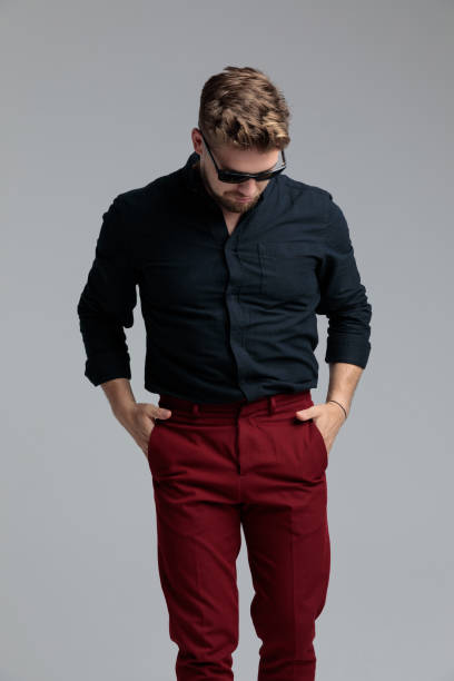 istock Pensive fashion man holding both hands in his pockets 1185405390