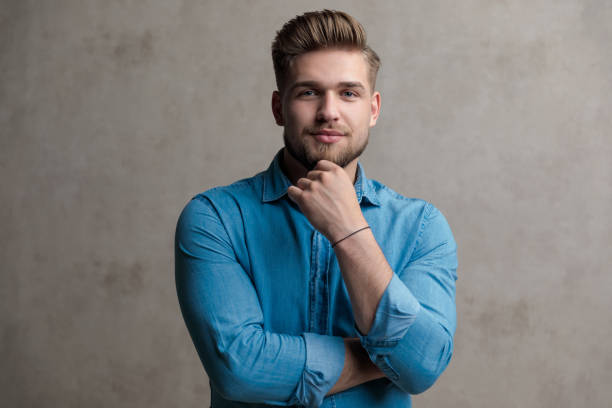 istock Serious casual holding his hand on his chin and thinking 1185405629
