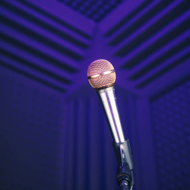 istock golden microphone on stand, purple background with acoustic foam in studio 1185405986
