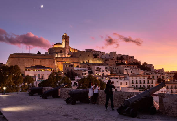sunset in Ibiza town and cathedral Ibiza,balearics,Spain, october 4, 2019. Beautiful sunset in the historic area of Dalt Vila in Ibiza,Balearics,Spain.Cathedral and white houses in the wall area ibiza town stock pictures, royalty-free photos & images