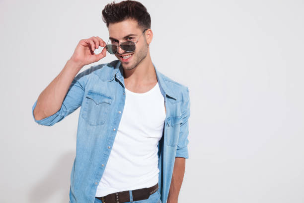 istock Cheerful casual man taking off his sunglasses and laughing 1185406979