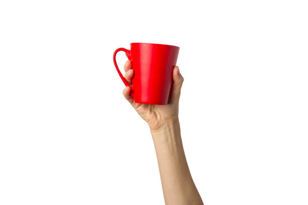 istock Female hand holding a red cup with hot coffee or tea on a white background. Coffee break concept, breakfast 1185407224