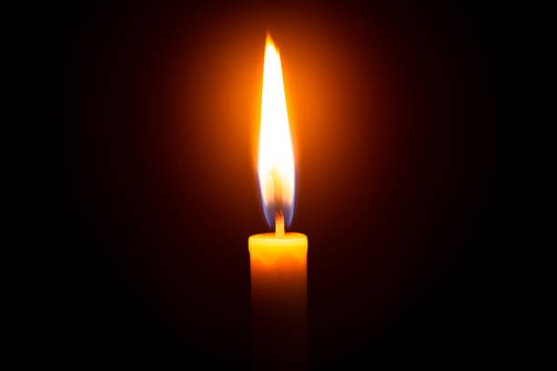 istock Candles and black background,Single lit candle with quite flame 1185407450