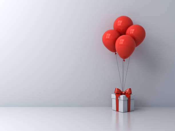 istock White present box or gift box with red balloons isolated on white room background with blank space on the left 1185409935